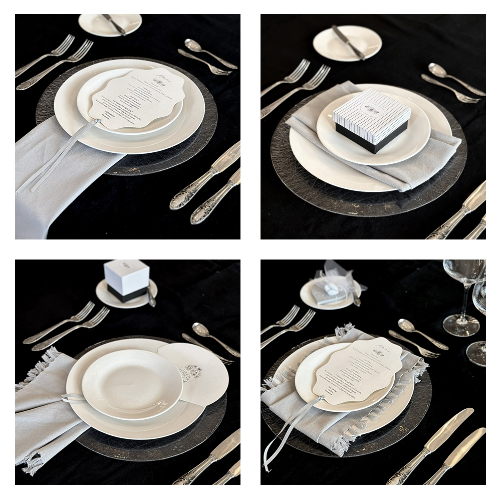Minimal στρώσιμο τραπεζιού γάμου με λευκά πιάτα, πετσέτα και μπομπονιέρα σε μαύρο τραπεζομάντηλο